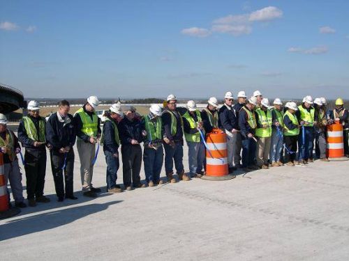 Workers and crew cut the ribbon.