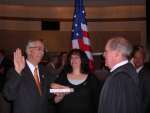Eugene is sworn in by Judge Horne, while his wife, Sheila Delgaudio, holds the Bible.
